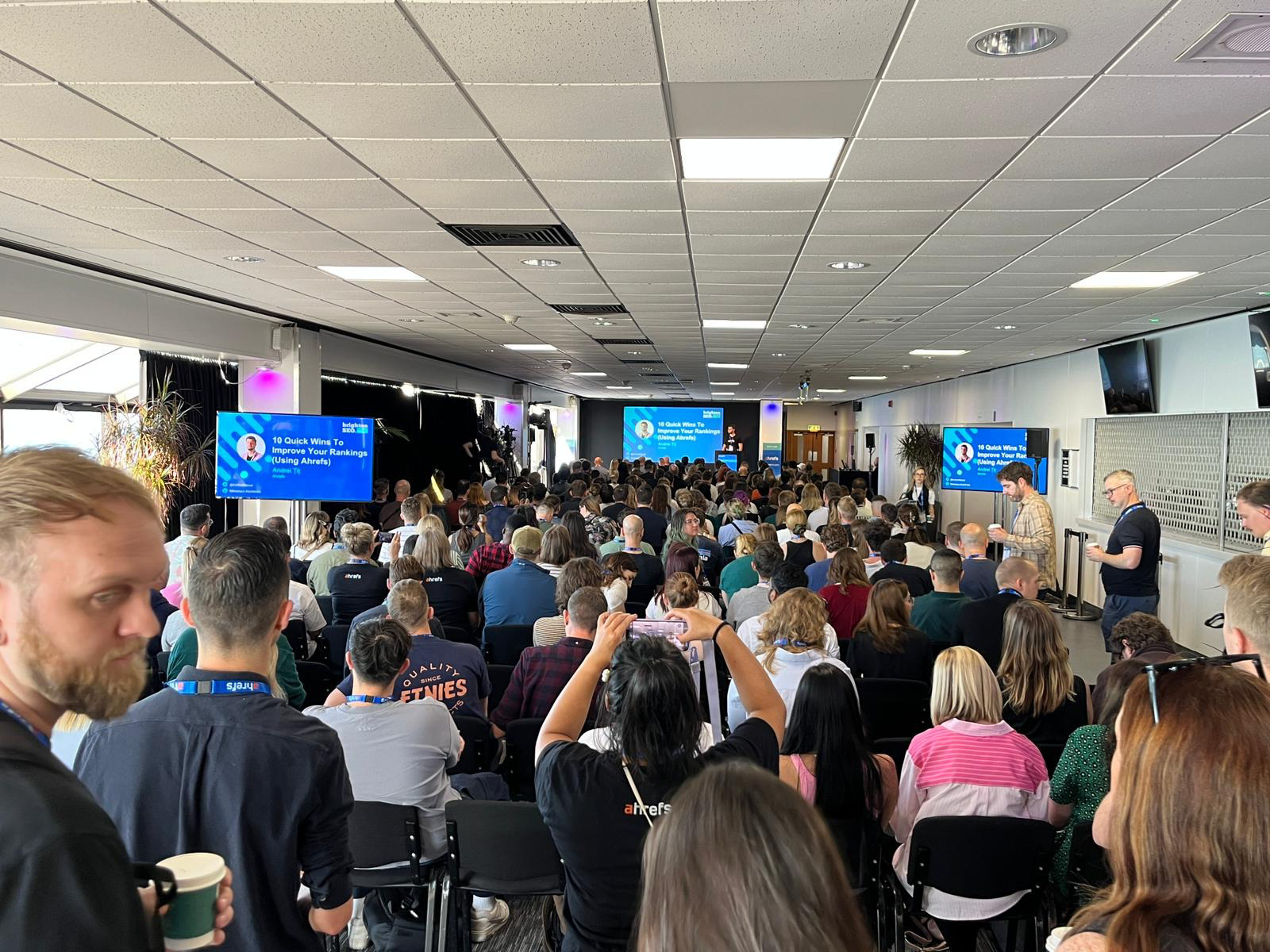 Dear BrightonSEO, You've Come a Long Way, Baby | Andrei Țiț speaking in front of a crowd at BrightonSEO