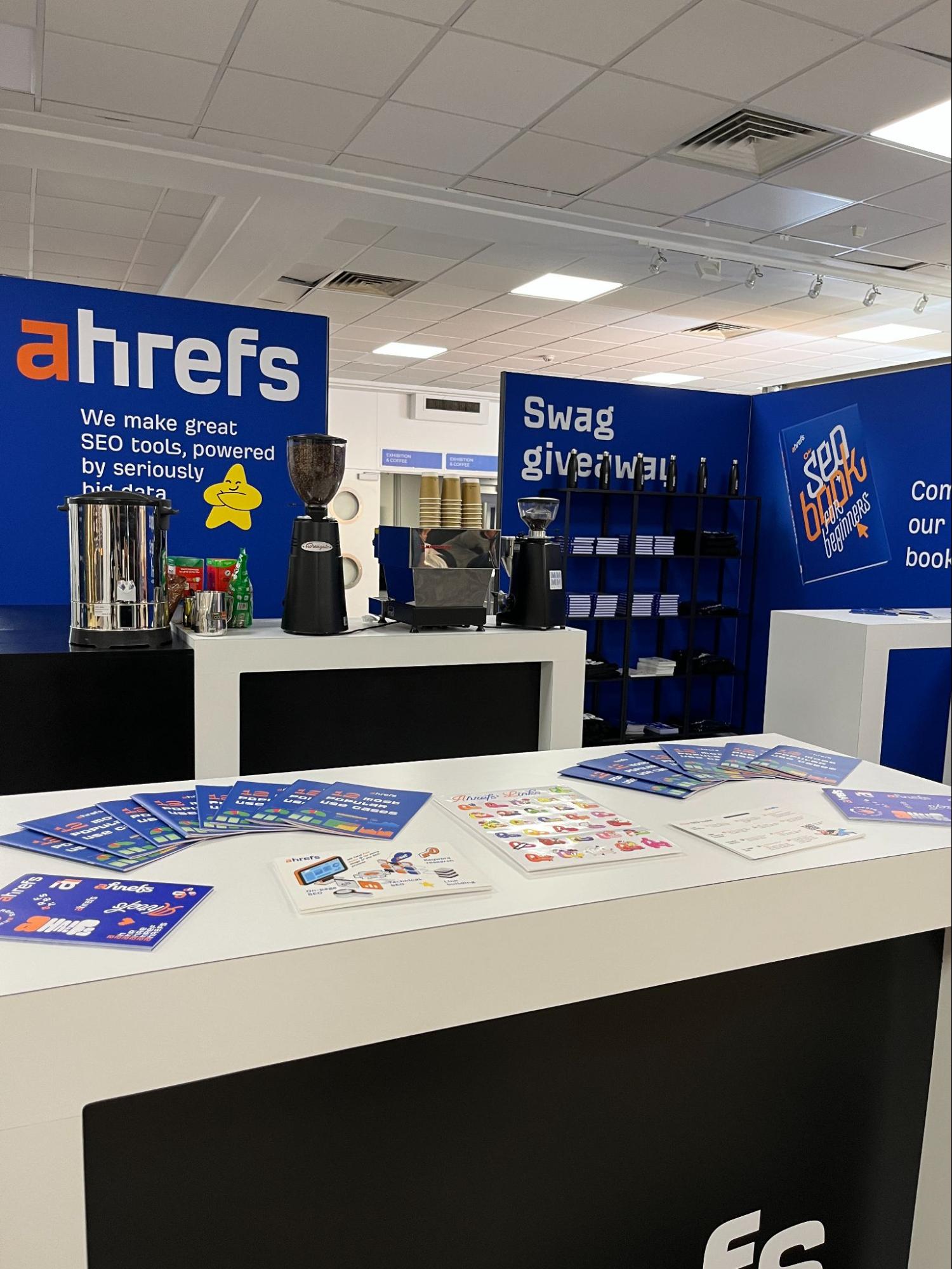 Dear BrightonSEO, You've Come a Long Way, Baby | Ahrefs' fully stocked exhibitor stand