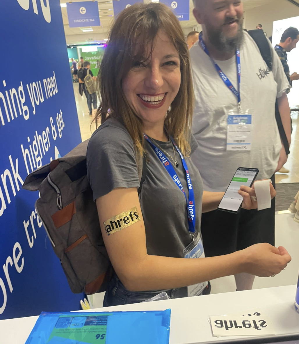 Dear BrightonSEO, You've Come a Long Way, Baby | Customer getting a temporary Ahrefs tattoo