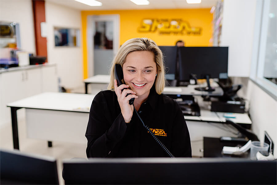 Location Landing Pages: 6 Crucial Elements Of Local Visibility | mage of Sheen Panel Services reception area with smiling, friendly receptionist.