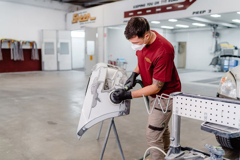 Location Landing Pages: 6 Crucial Elements Of Local Visibility | Example image of a Sheen Pane Services team member repairing a vehicle door.