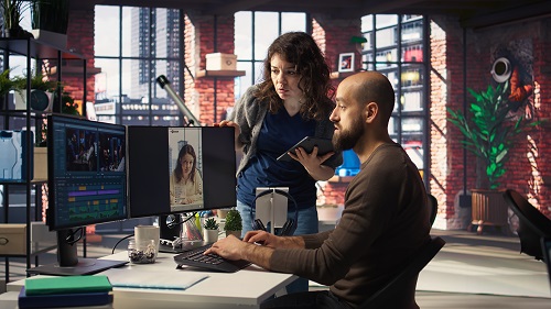Professional editor uses AI powered software and PC reels in a creative office