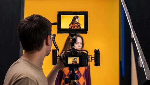Professional photographer shooting a young woman