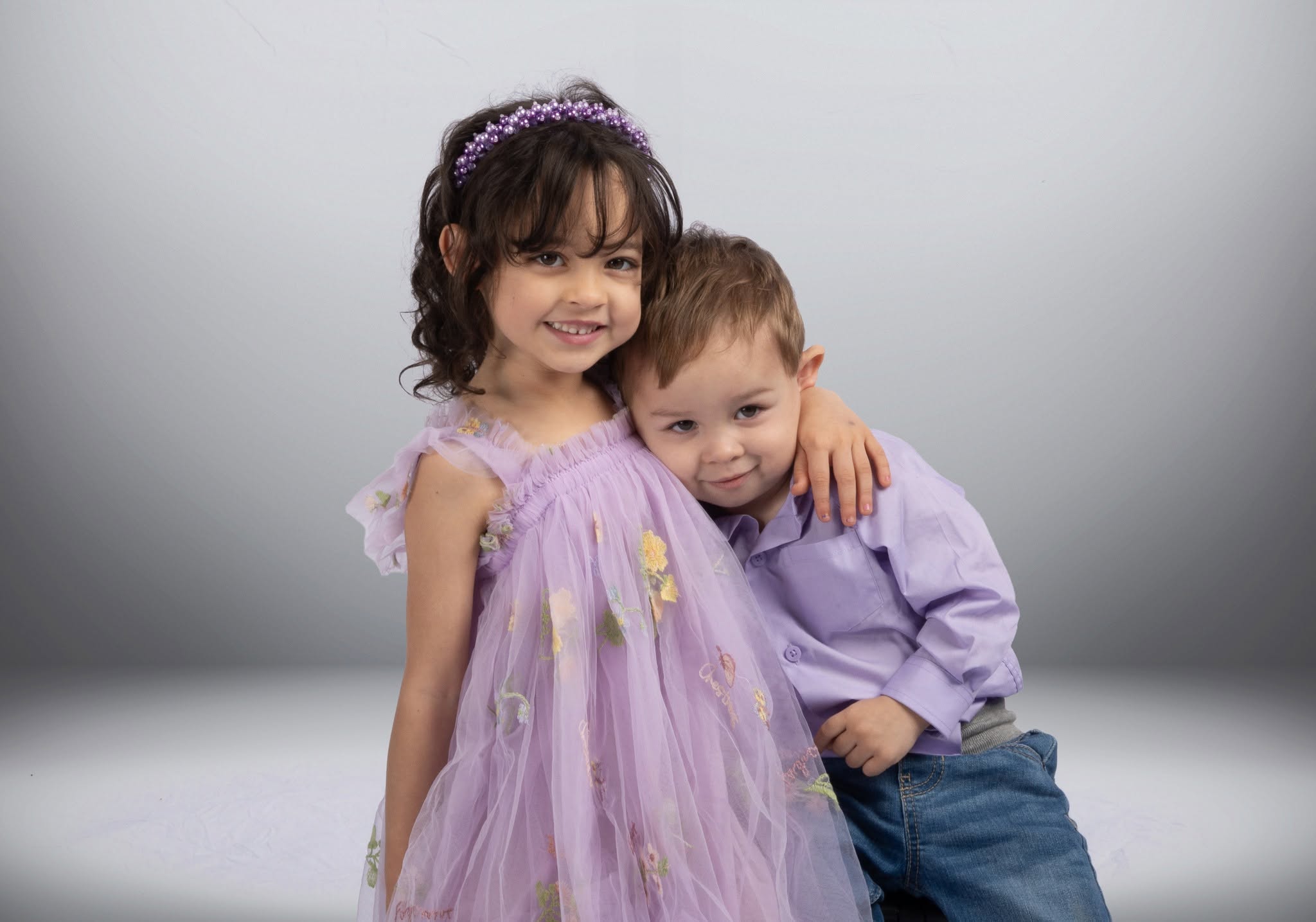 Two children posing together happily.