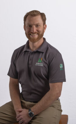 Person sitting in a gray polo.