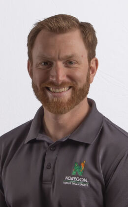 Man in polo shirt, neutral background.